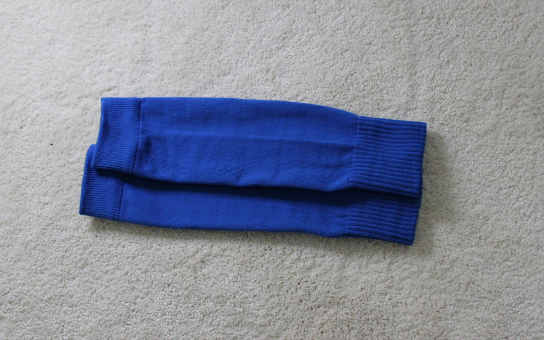 316 XI Soccer Sleeves blue colorway back view showing compression fit on pitch
